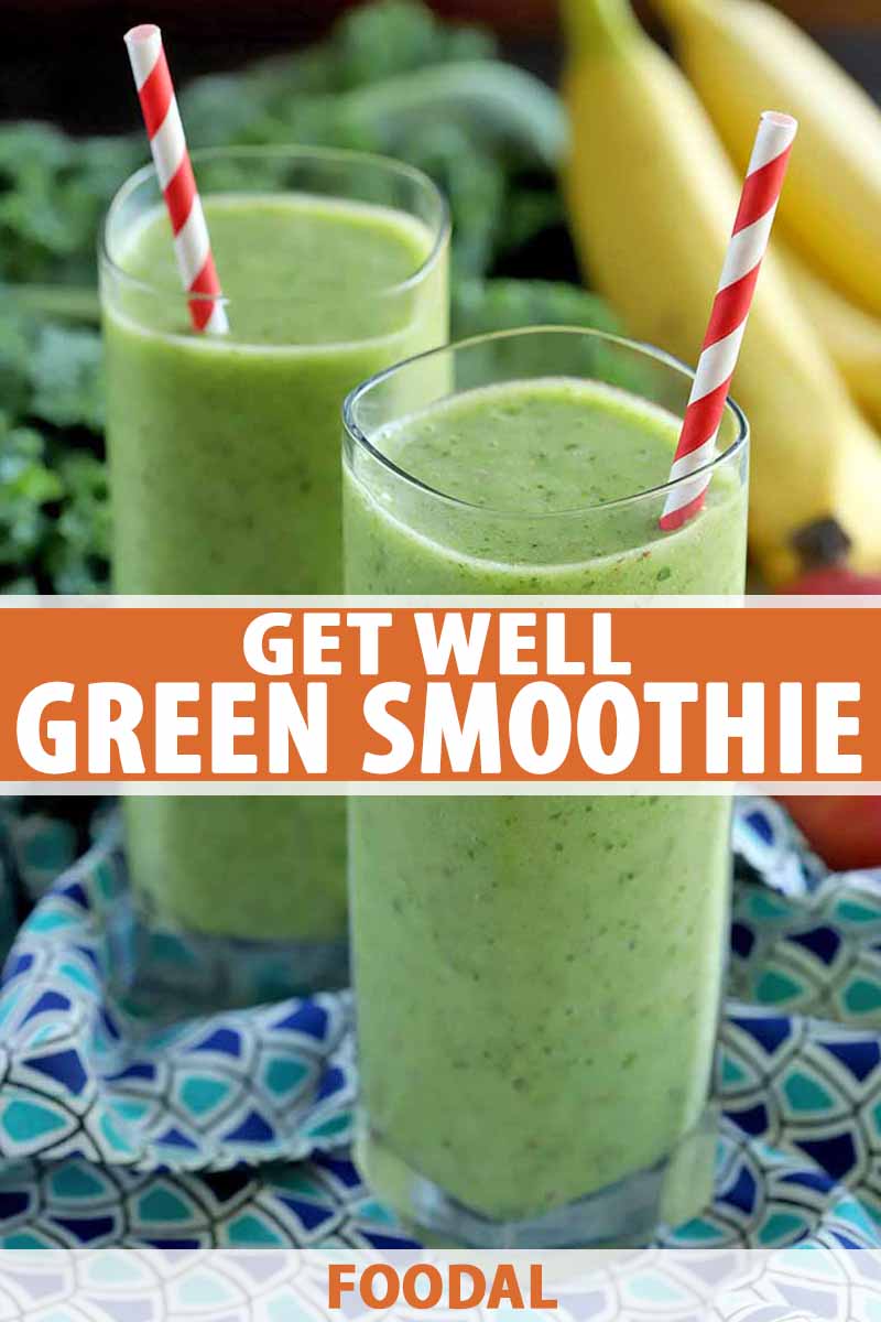 Vertical shot of two tall glasses of green smoothie, with red and white striped paper straws, on a dark and light blue patterned cloth with bunches of kale and bananas in the background, printed with orange and white text.