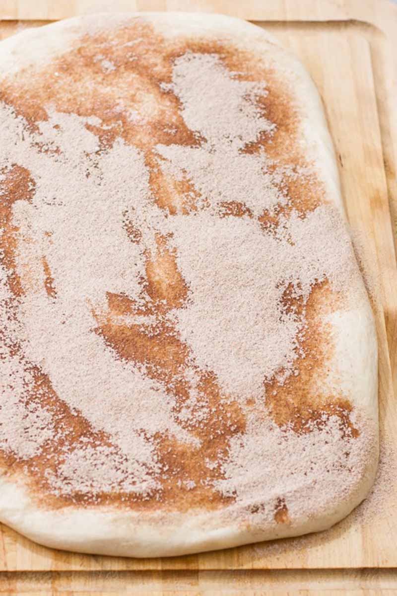 Vertical image of dough with cinnamon and sugar.