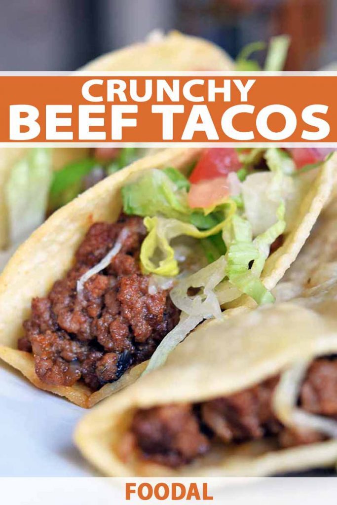 Vertical closeup image of three hard shell beef tacos with shredded lettuce, diced tomato, and melted sharp cheddar cheese, on a white plate, printed with orange and white text at the bottom and midpoint of the frame.