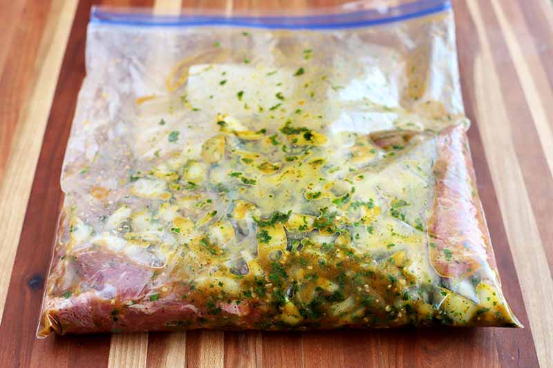 Horizontal image of steak in a bag with marinade.