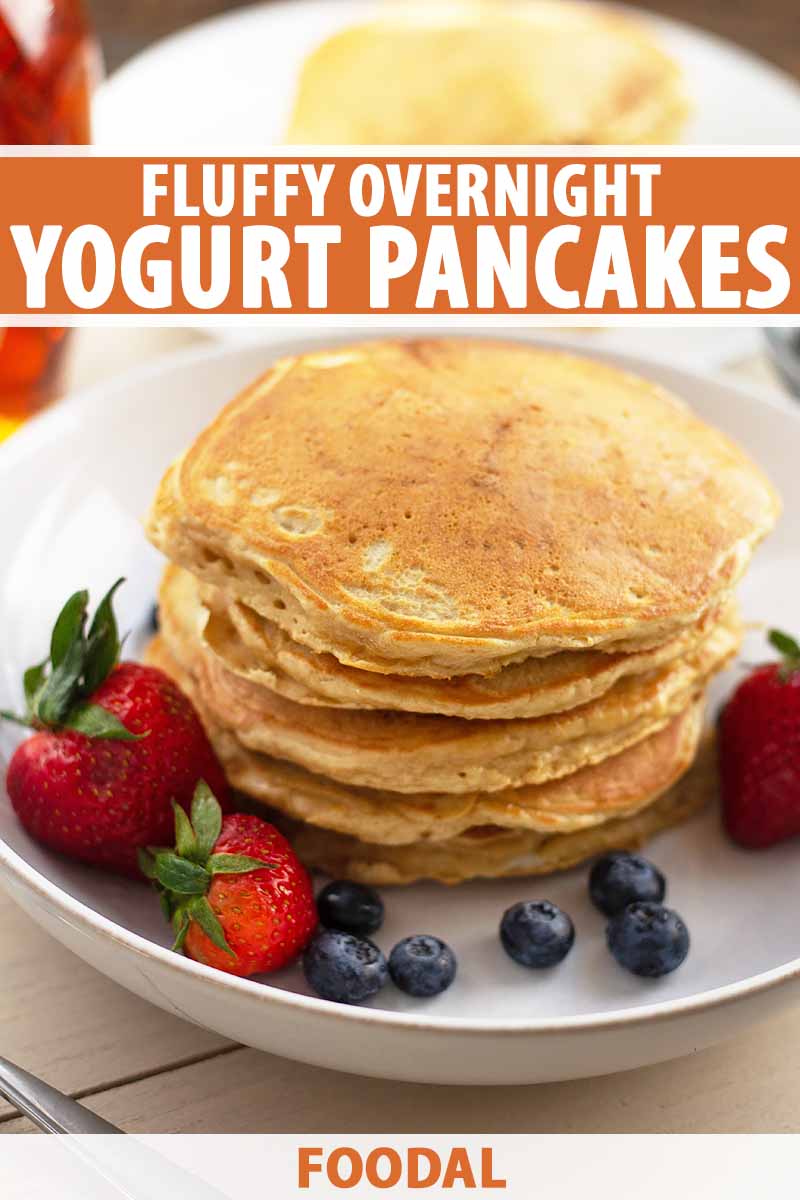 Vertical image of a tall plain stack of flapjacks on a white dish with berries, with text on the top and bottom of the image.