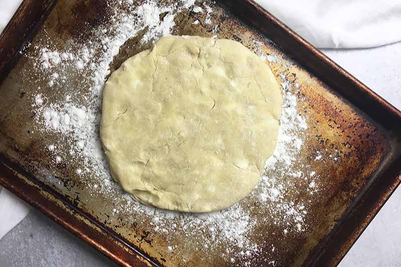 Horizontal image of a sheet pan with a rolled out dough.