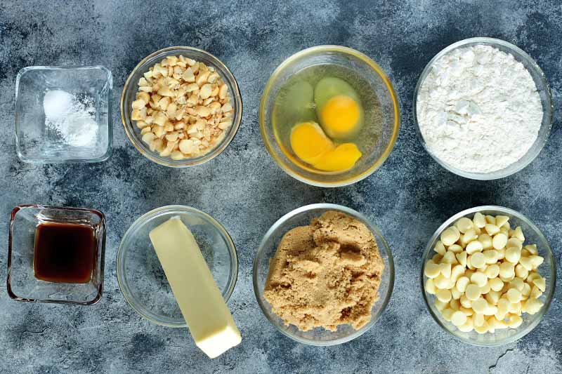 Horizontal image of assorted ingredients to make white chocolate nut desserts.