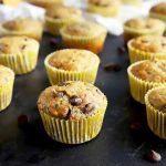 Horizontal image of a banana muffins with chocolate chips on a black surface