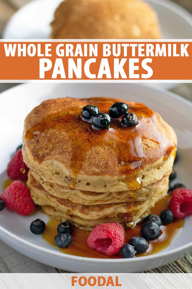 Vertical image of a stack of pancakes with maple syrup and berries in a white shallow bowl, with another dish of flapjacks in the background, on an unfinished wood surface, printed with orange and white text in the upper third and at the bottom of the frame.