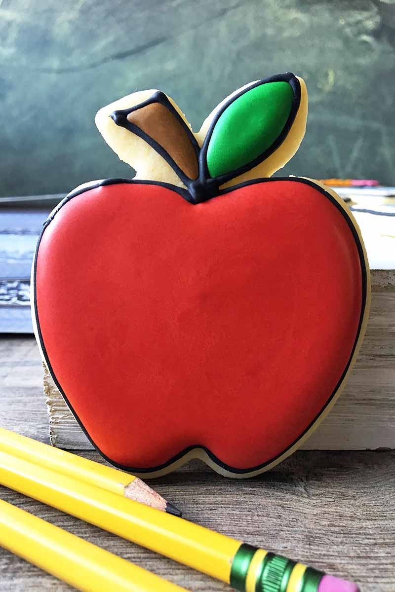 Vertical image of a bright red apple cookie.