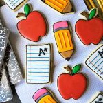 Horizontal top-down image of assorted back to school decorated desserts.