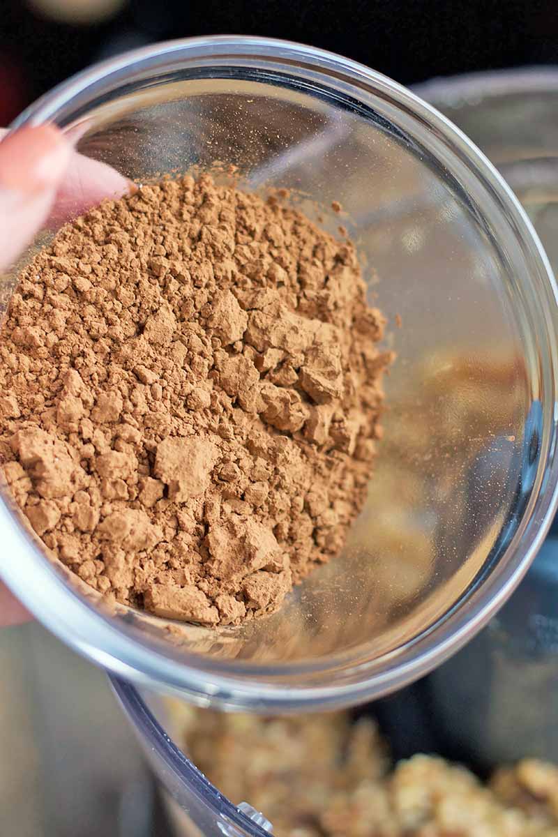Vertical close-up image of a bowl of cocoa powder.