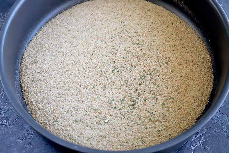 Horizontal image of a frying pan with dry breadcrumbs.