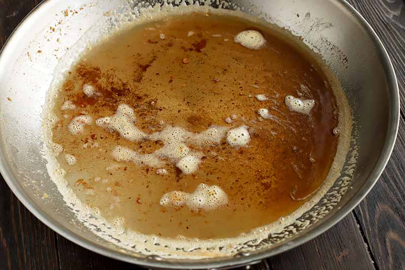 Horizontal image of brown butter in a pan.
