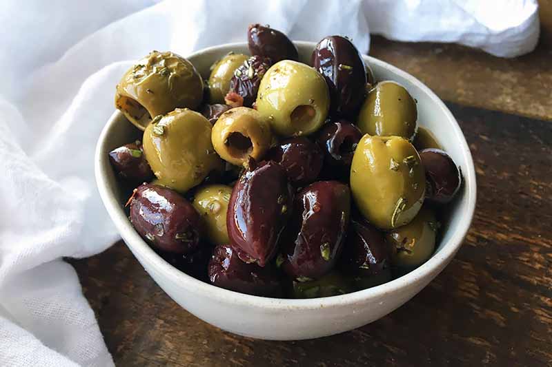 Horizontal image of a bowl of assorted olives.