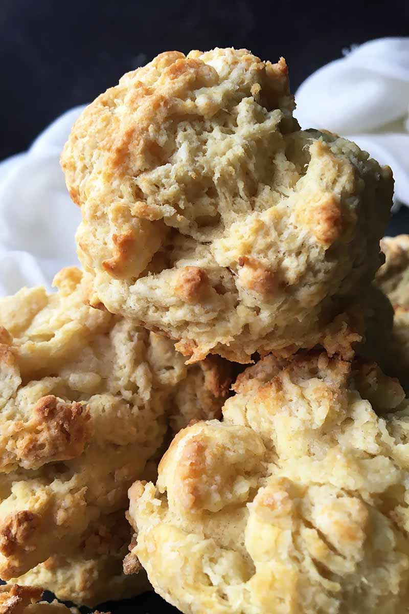 Vertical image of a mound of drop biscuits.
