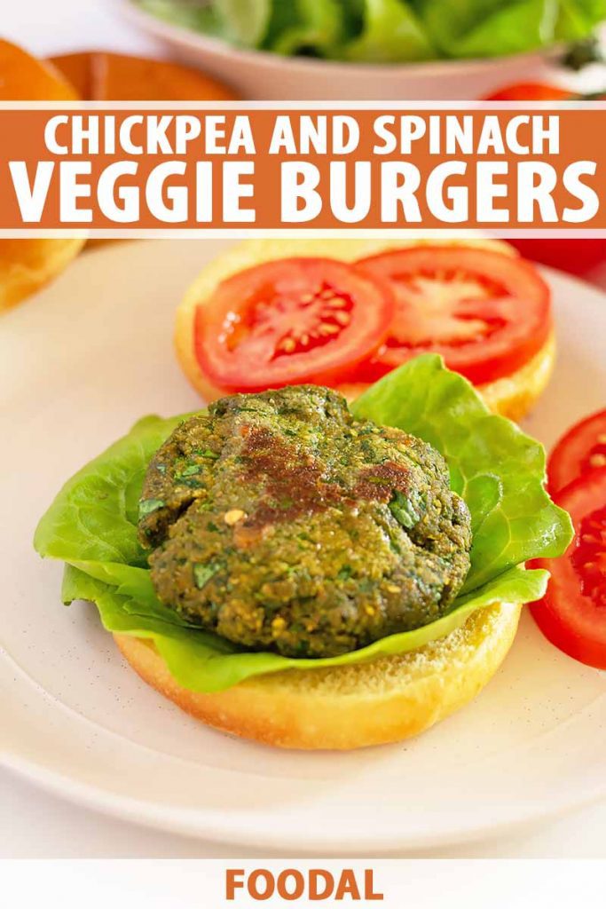 Vertical image of an open-faced green veggie burger on lettuce next to a plate with sliced tomatoes, with text on the top and bottom of the image.