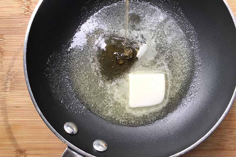Horizontal image of a pan with melted butter and syrup pouring into the pan.