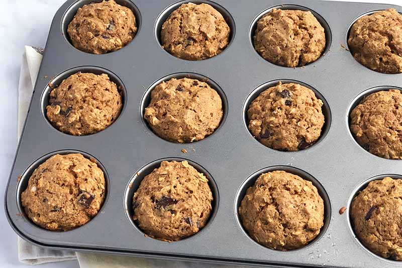 Horizontal image of baked muffins in a pan.