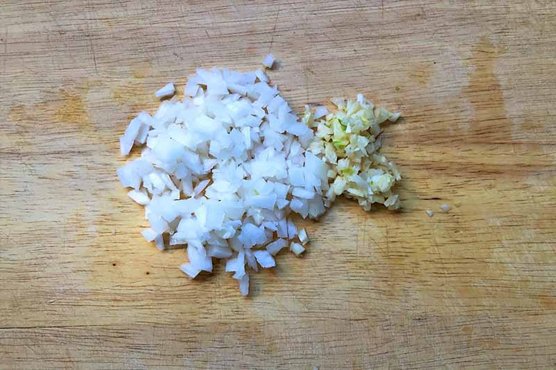 Horizontal image of chopped onion and garlic.