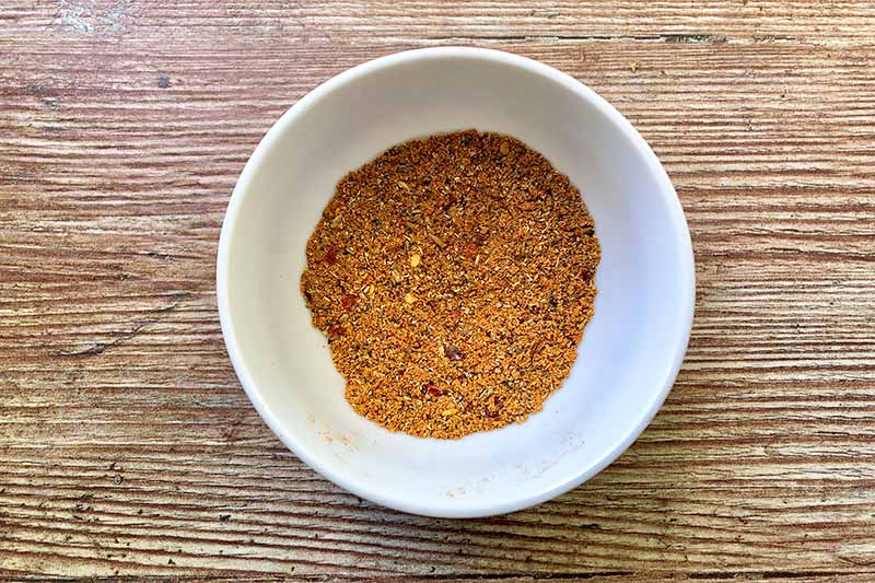 Horizontal image of a spice mix in a small white bowl.