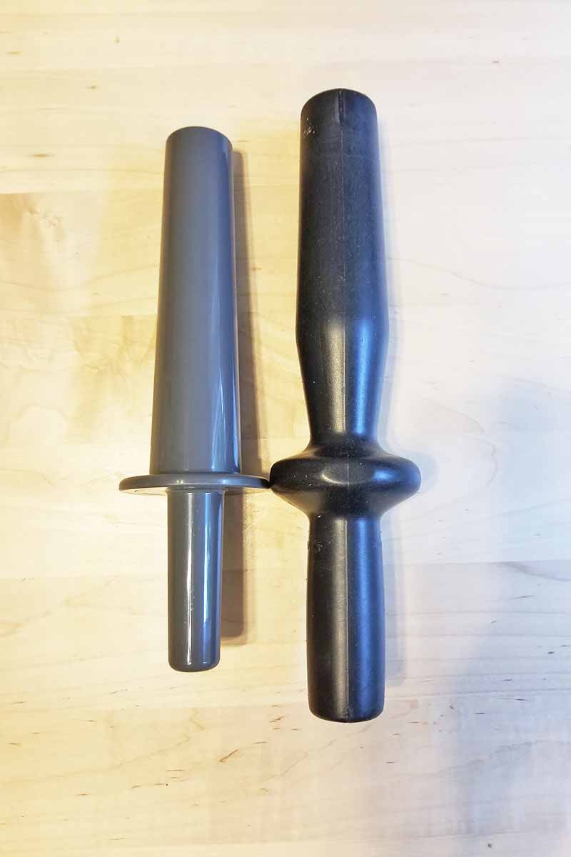 Vertical image of two plastic tampers.
