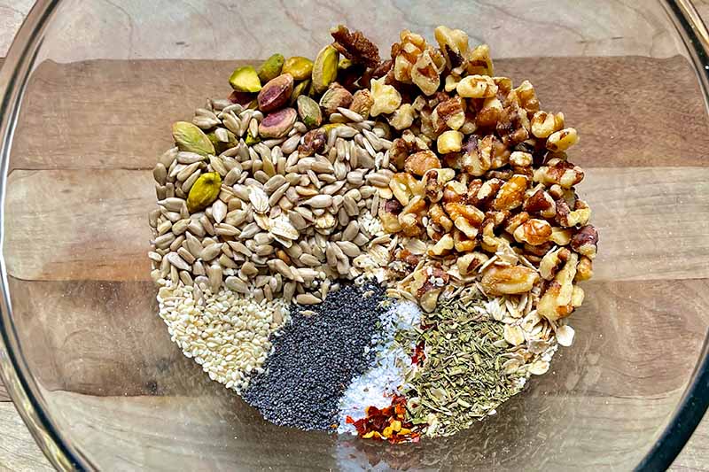 Horizontal image of mounds of dry ingredients in a glass bowl.