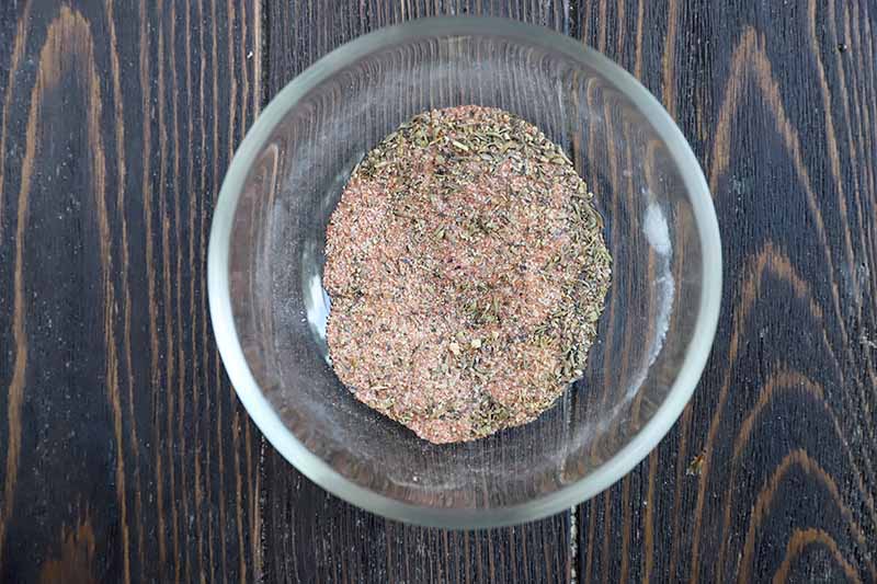 Horizontal image of a spice mixture in a glass bowl.