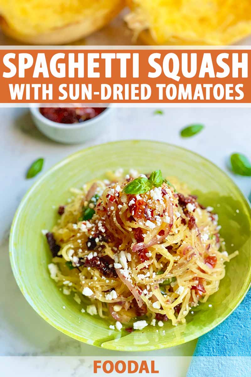 Vertical image of a green plate filled with strands of yellow vegetables topped with a chunky red sauce with cheese crumbles and basil garnish, with text on the top and bottom of the image.