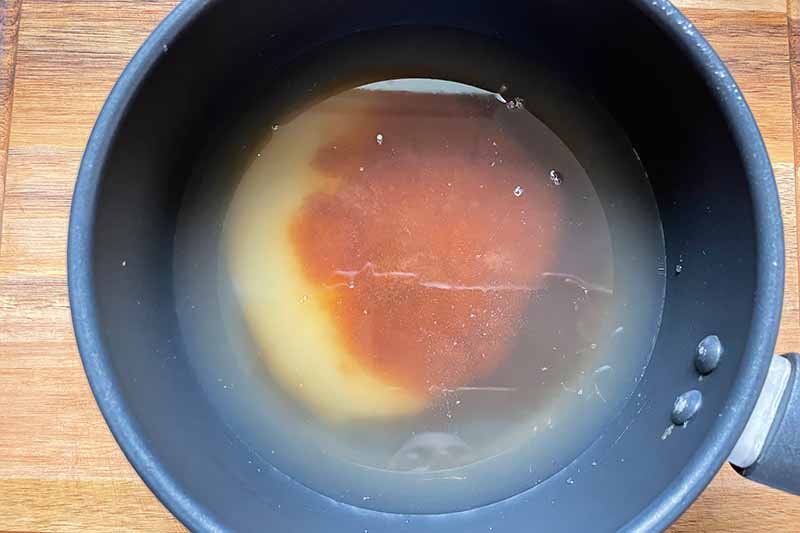 Horizontal image of mixed liquids in a pot.