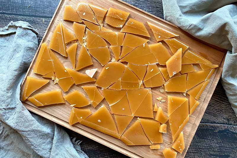 Horizontal image of pieces of hard caramels on a cutting board.