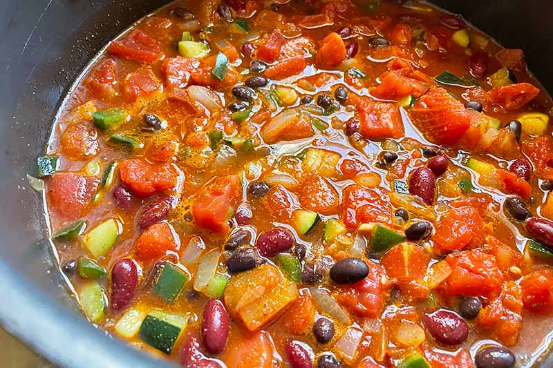 Horizontal image of vegetable chili in a pot.