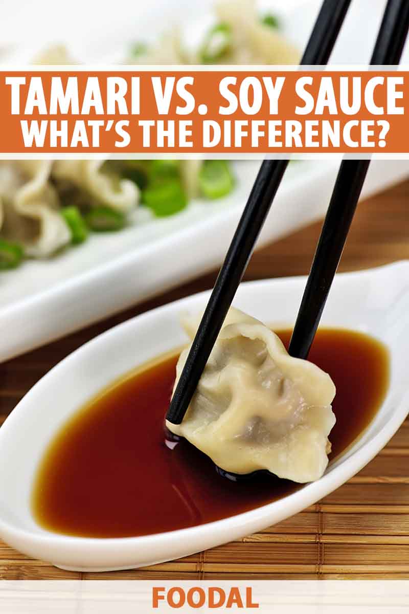 Vertical image of chopsticks dipping a dumpling in soy sauce in a white dish over a bamboo mat.