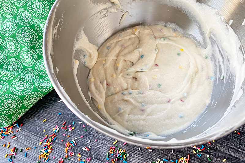 Horizontal image of confetti batter in a metal bowl.