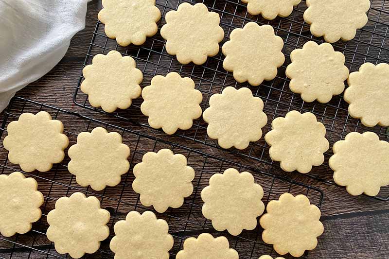 Horizontal image of baked floral cookies cooling.