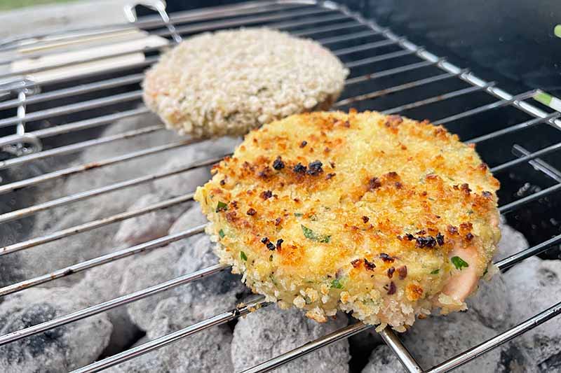 Horizontal image of grilling breaded patties.
