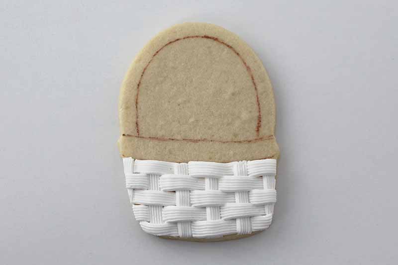 Horizontal image of a half-piped cookie shaped like a basket.