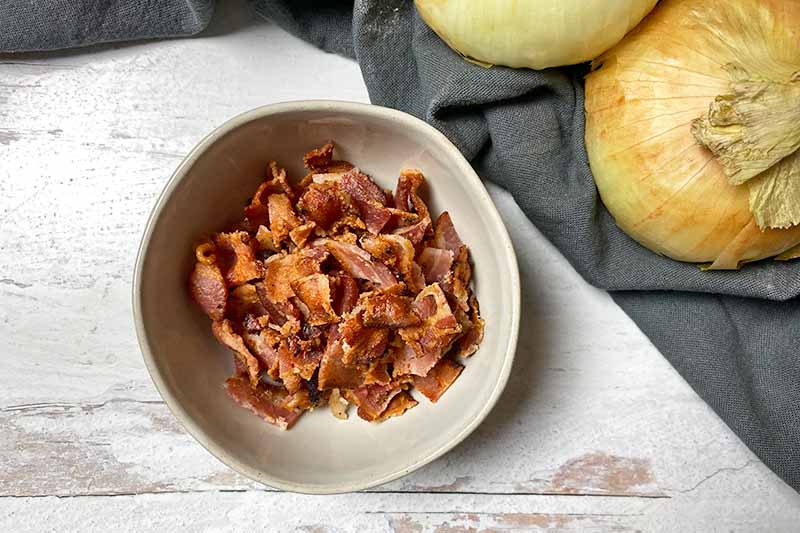 Horizontal image of chopped bacon in a bowl.