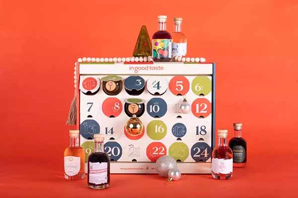 Image of a color-blocked advent calendar surrounded by assorted bottles.
