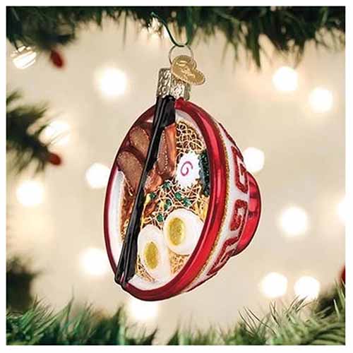 Image of a ramen bowl ornament hanging on tree branches.