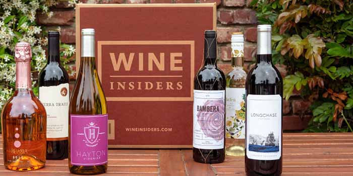 Image of assorted bottles of wine in front of a Wine Insiders package.