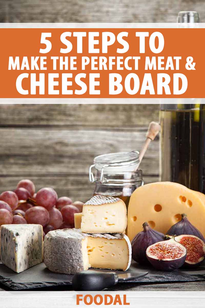 Vertical image of a large charcuterie spread, with text on the top and bottom of the image.