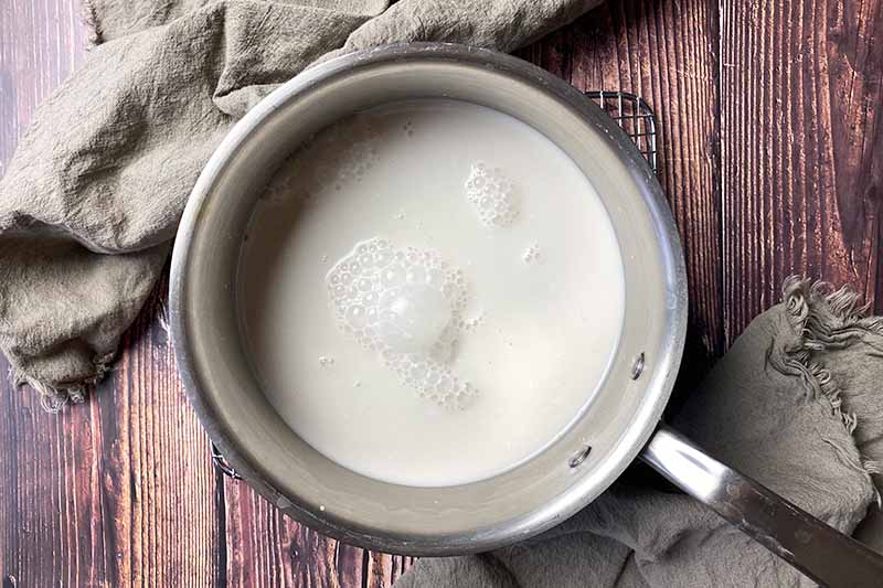 Horizontal image of a pot filled with milk.