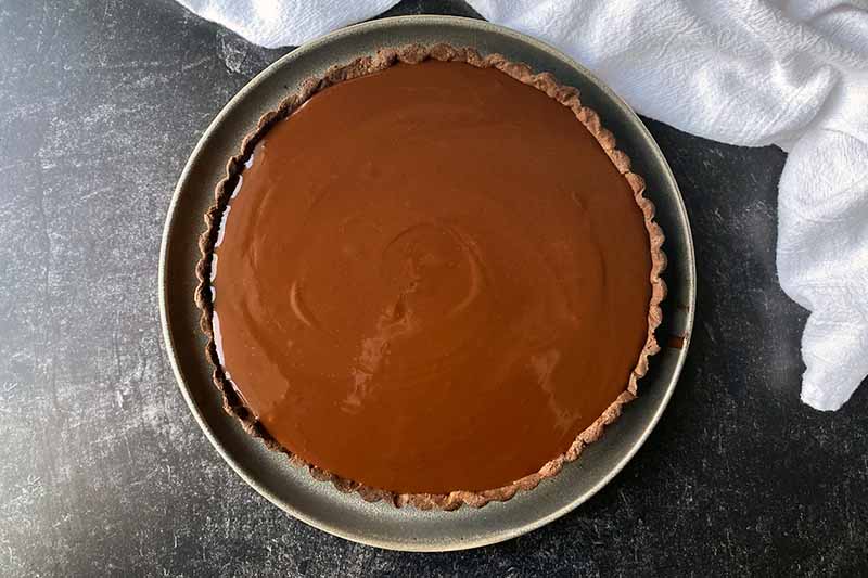 Horizontal image of an unset ganache in a pastry crust.