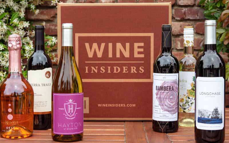 Image of the Wine Insiders Membership, surrounded by bottles.