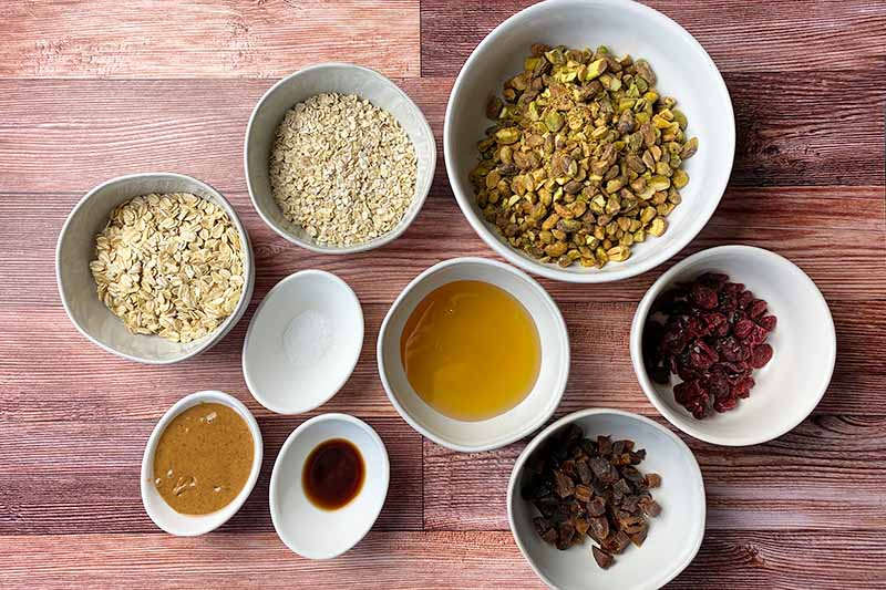 Horizontal image of white bowls filled with wet and dry prepped and measured ingredients.