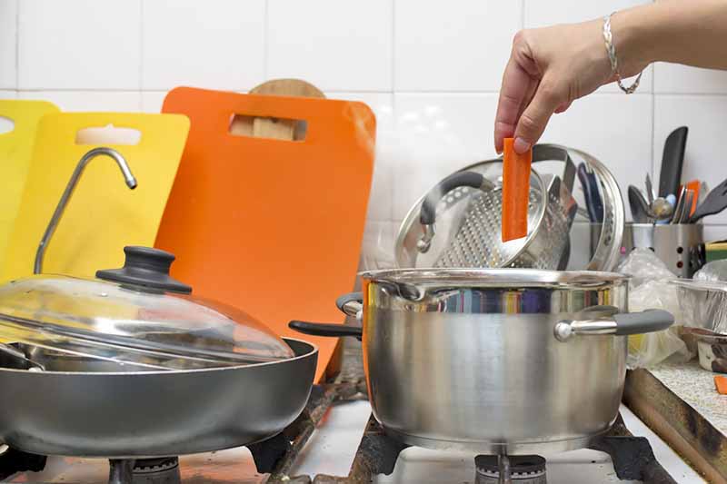 Horizontal image of a cluttered stovetop.