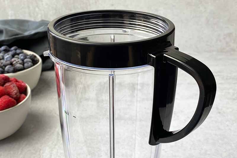 Horizontal image of a handled ring attachment on a plastic cup.