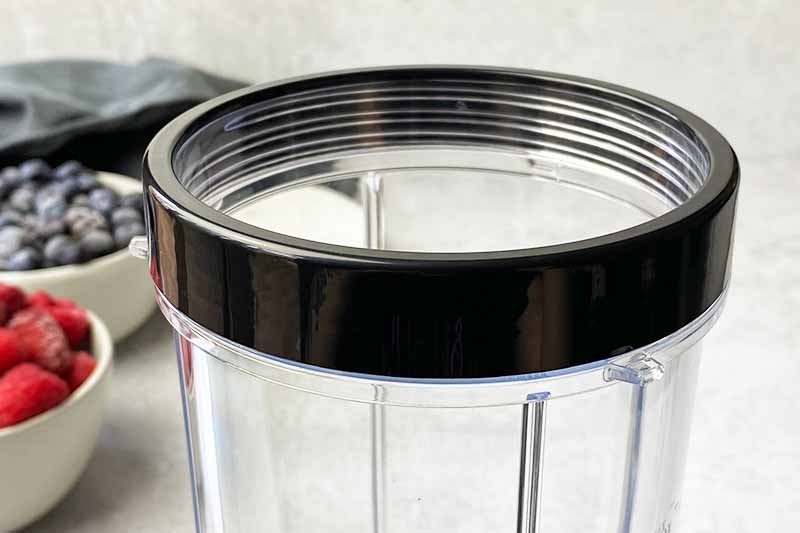 Horizontal image of a cup ring attachment on a plastic container.