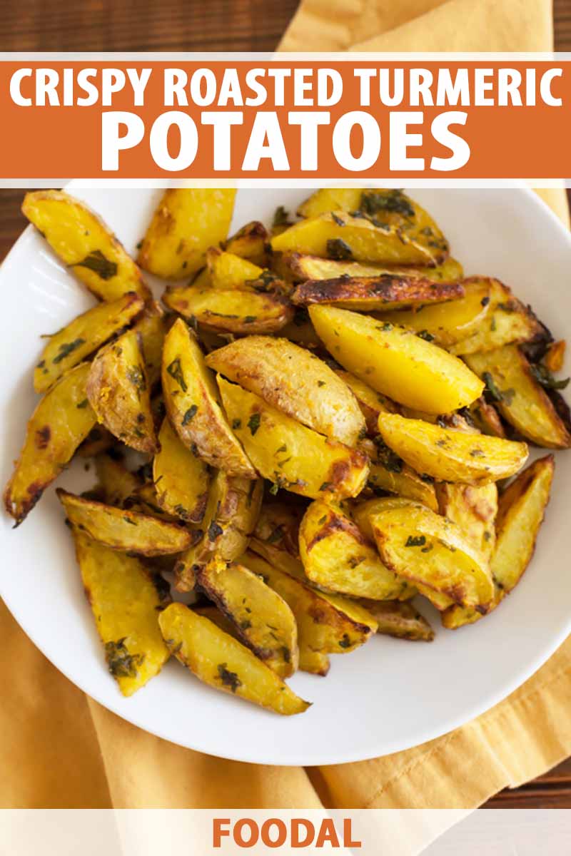 Vertical image of a white plate filled with potato wedges in seasoning.
