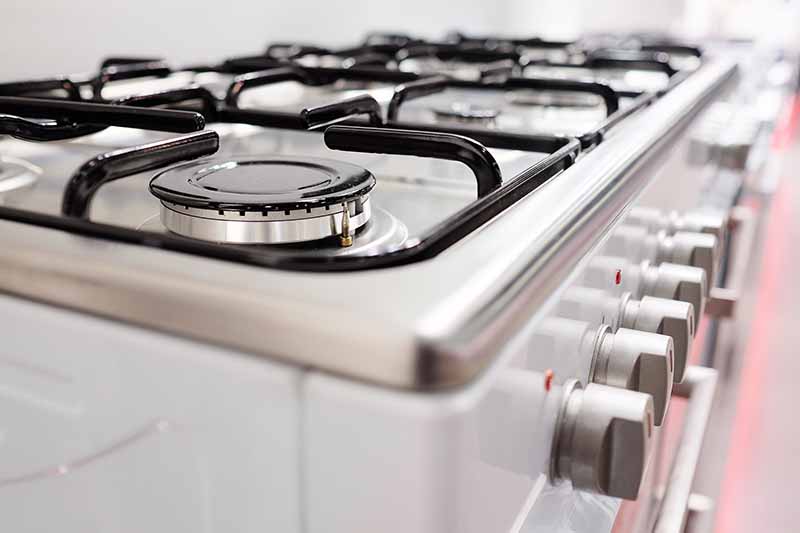 Horizontal closeup image of a gas stove.