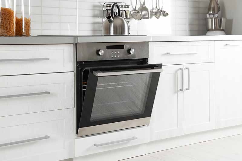 Horizontal image of an oven built in a kitchen countertop.