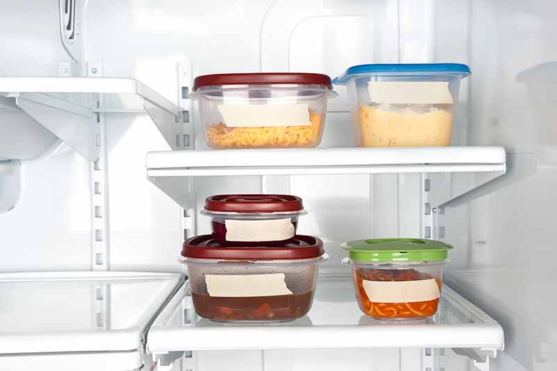 Horizontal image of assorted food in containers with blank tape.