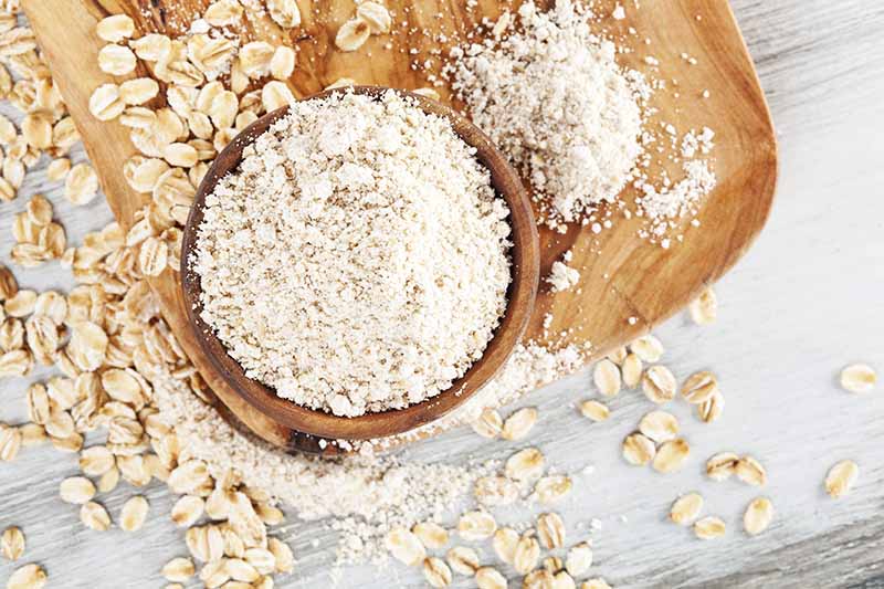 Horizontal image of pulverized oats in a wooden bowl.